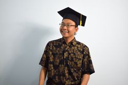 Happy graduate in studio shoot