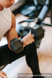 Cropped image of a man training his arm with a dumbbell 4BEq35