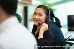 Smiling female operator working in call center 5ll265