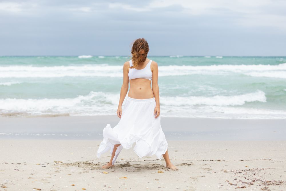 woman dancing near sea