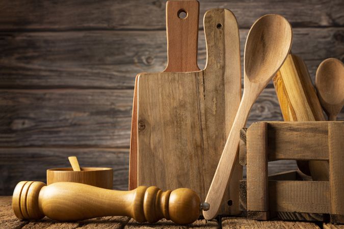 Wooden kitchen utensils on rustic background.