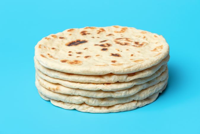 Naan bread isolated on blue background