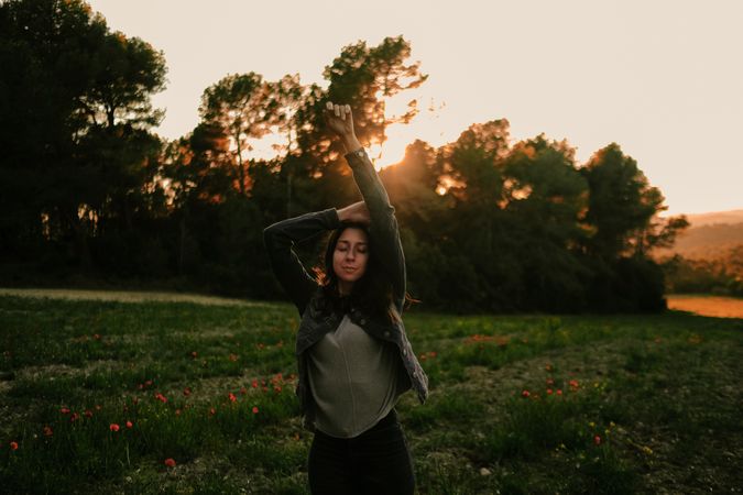 Woman walking on meadow and enjoying freedom