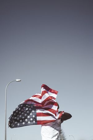 Casual man with American flag on street