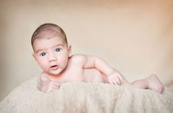 Portrait of newborn baby lying down over a blanket