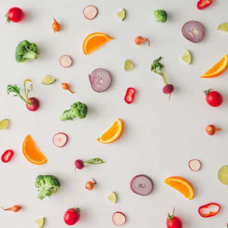 Colorful vegetable pattern made of onion, broccoli, orange and radish