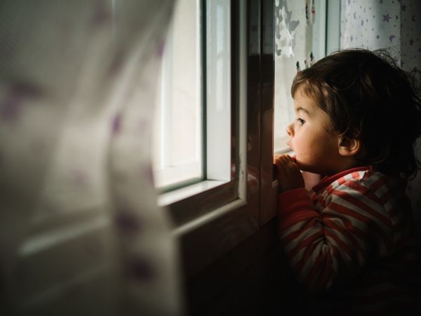 kid peering through window
