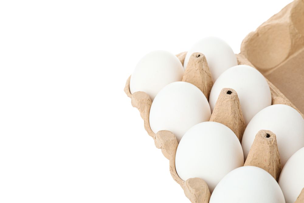 chicken eggs in carton box isolated on blank background