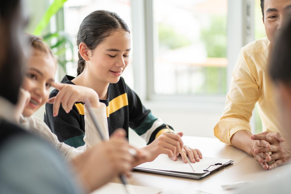 Happy female student with notepad in class