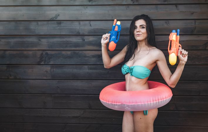 Young woman with two water guns posing