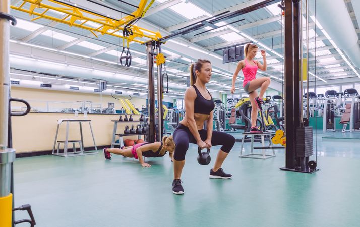 Group of fit women doing circuit training in gym
