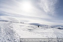 Person walking in distance of ski resort of Sierra Nevada in winter bY8vN4
