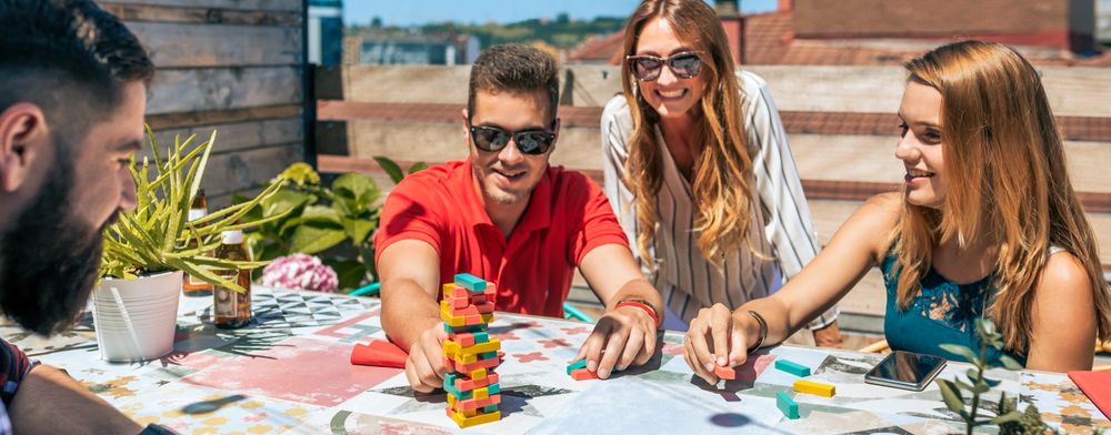 Group of office workers playing with game on terrace