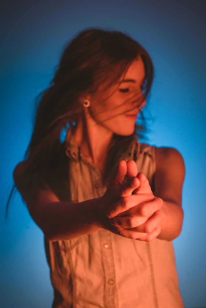 woman showing gun gesture
