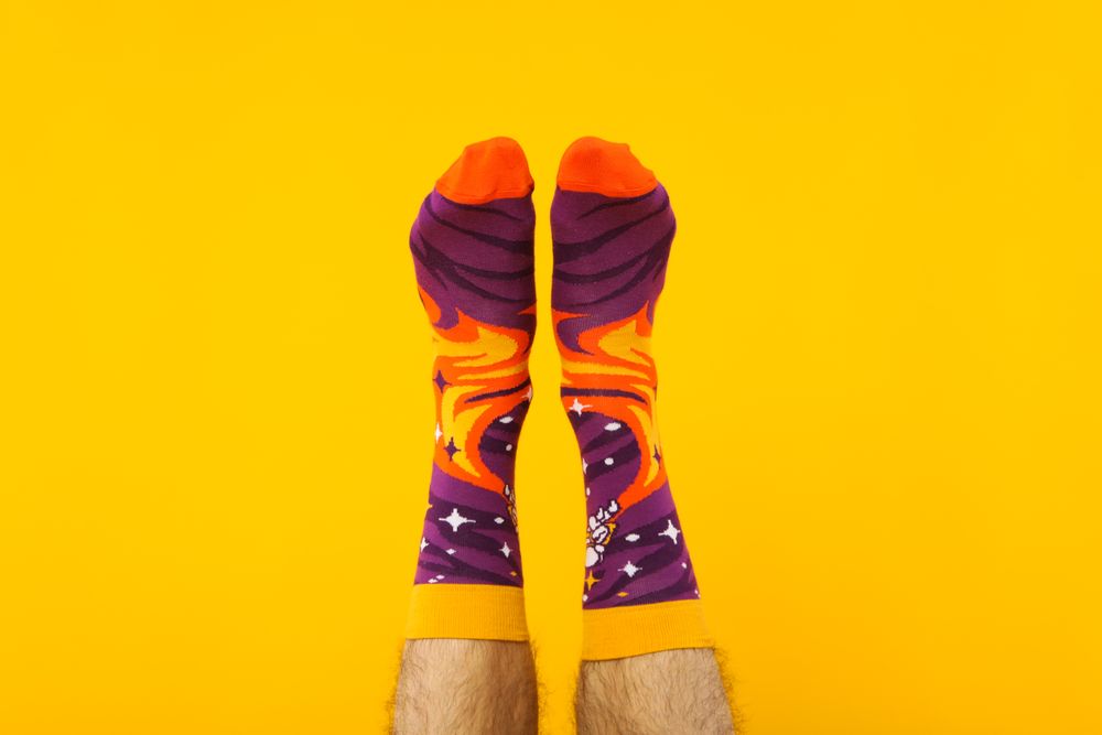 Concept of clothes for legs - socks, socks on male legs