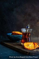 Side view of dried persimmon slices surrounding Turkish tea 5lVPl6