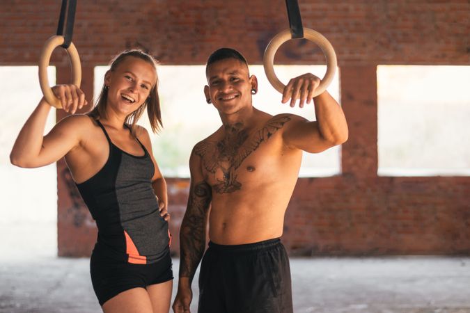 couple working out with gymnastic rings