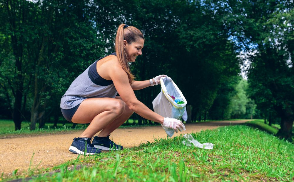 Woman with garbage bag doing plogging