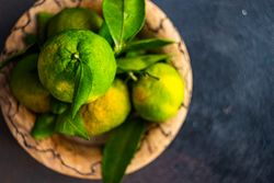 Top view of bowl of fresh green tangerines