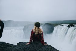 Back of woman overlooking waterfall