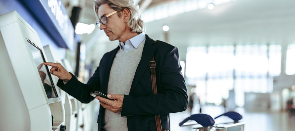 Business traveler using self-service airport check-in