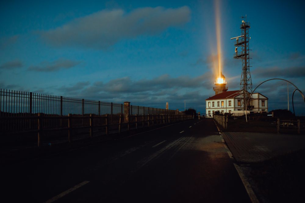 Road and lighthouse in evening