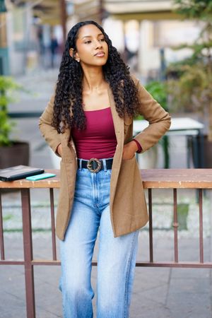A Stylish and Young Woman is Posing Outdoors with a Trendy and Fashionable Outfit
