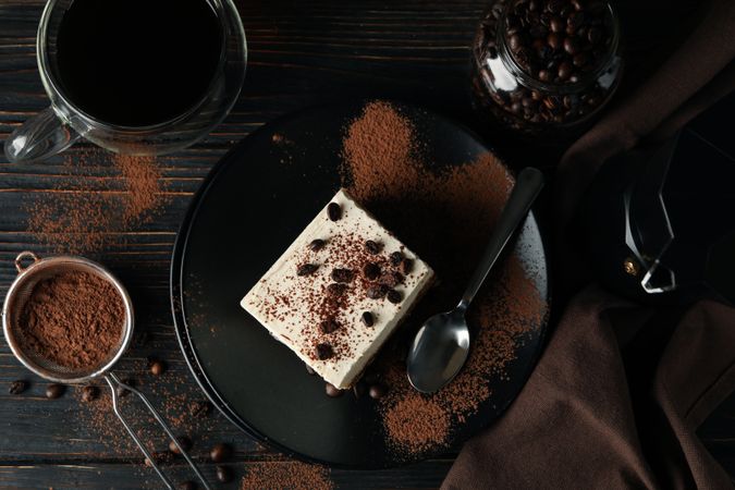 Composition with tasty tiramisu and coffee on wooden background
