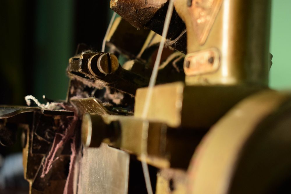 Side of string in tailor's bronze sewing machine