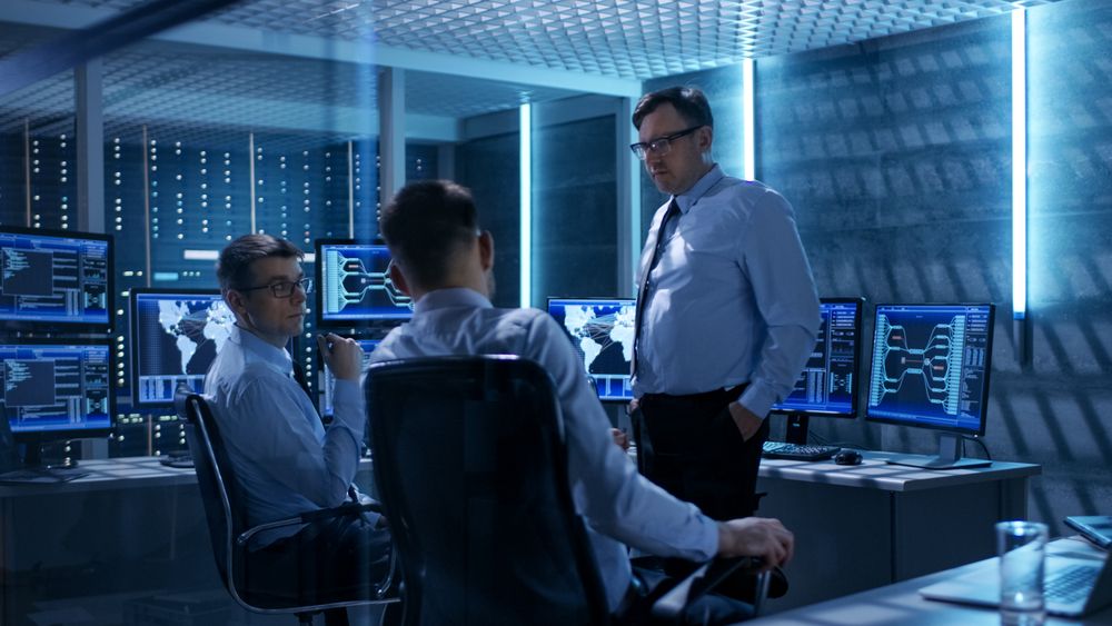 Team of Technical Moderators Have Discussion in Monitoring Room.