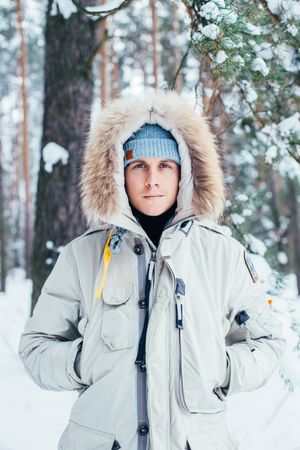 Man in parka on winter day, vertical