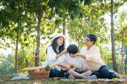 Asian family having picnic together at park on weekend 5klJo4