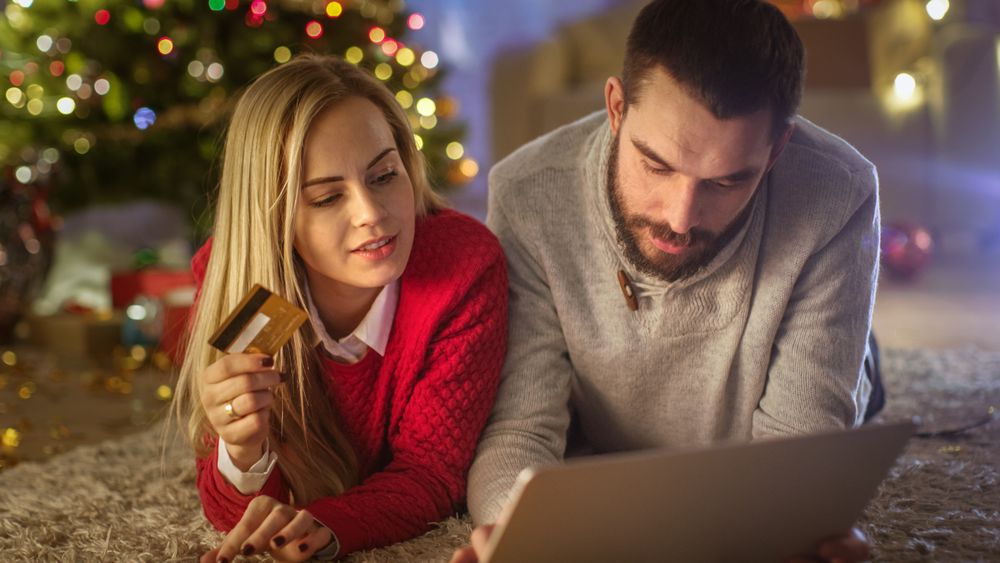 Happy Couple Lies On the Carpet Under Christmas Tree