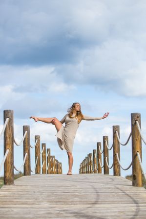 Young woman posing on footbridge