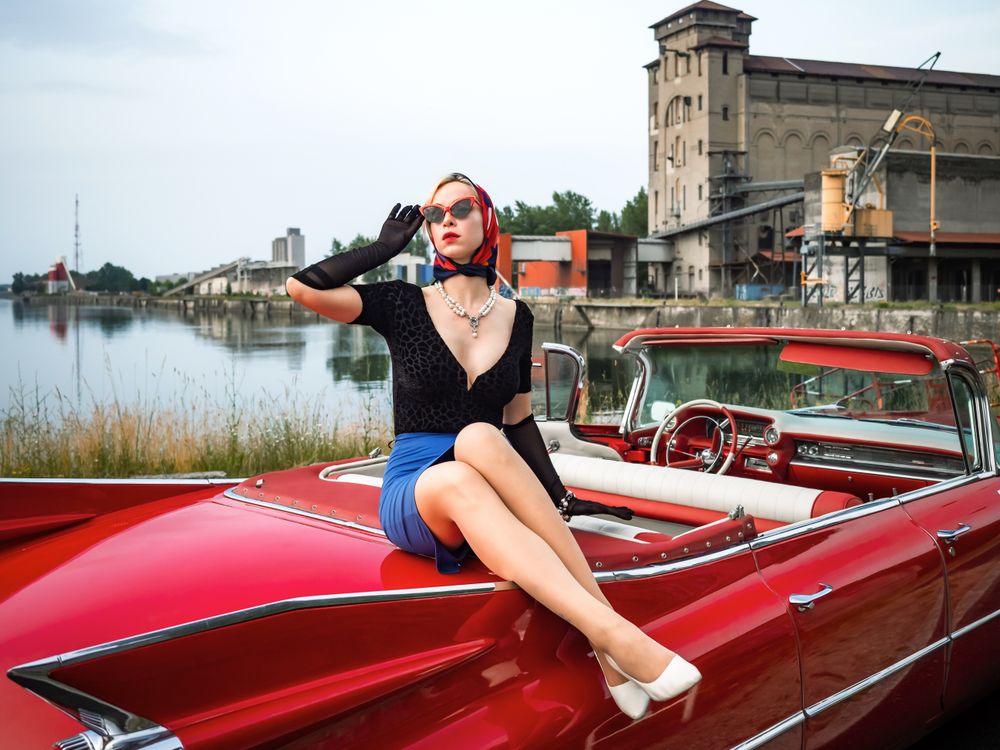 Retro red Cadillac with a woman sitting on top