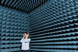 Woman in sound room listening to music