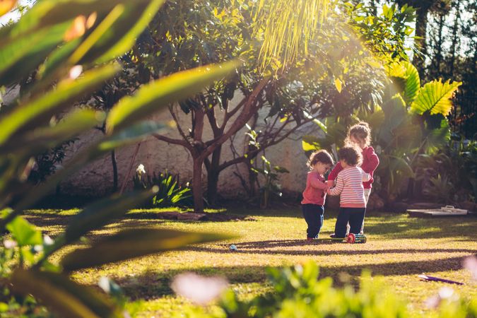 little kids holding hands in park