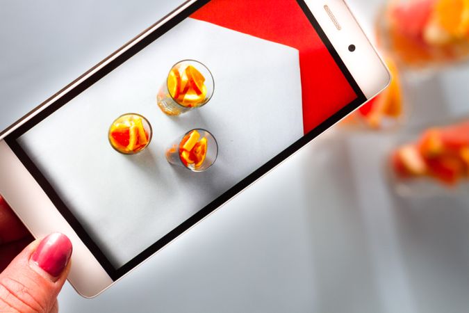 Photo of sliced citrus fruits on mobile phone