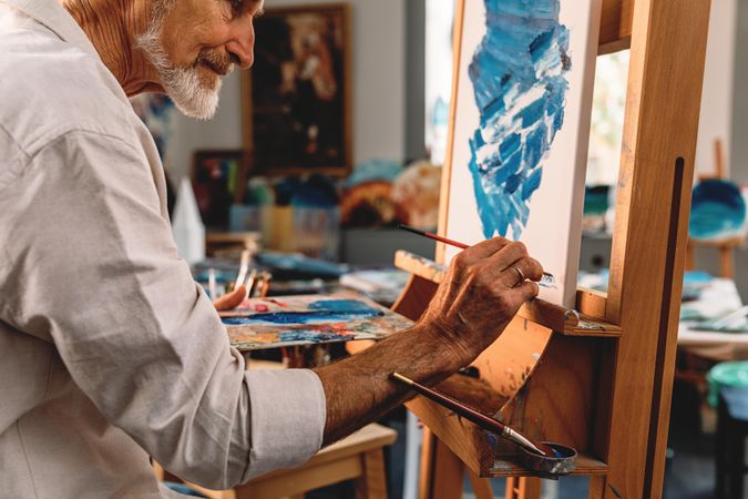 Man signing his painting in studio