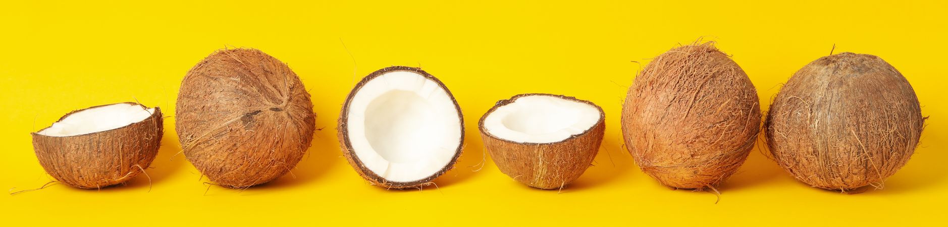Coconuts on yellow background. Tropical fruit. Summer
