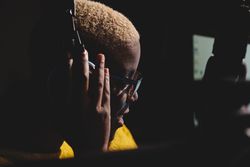 Black woman with headphones in dark room