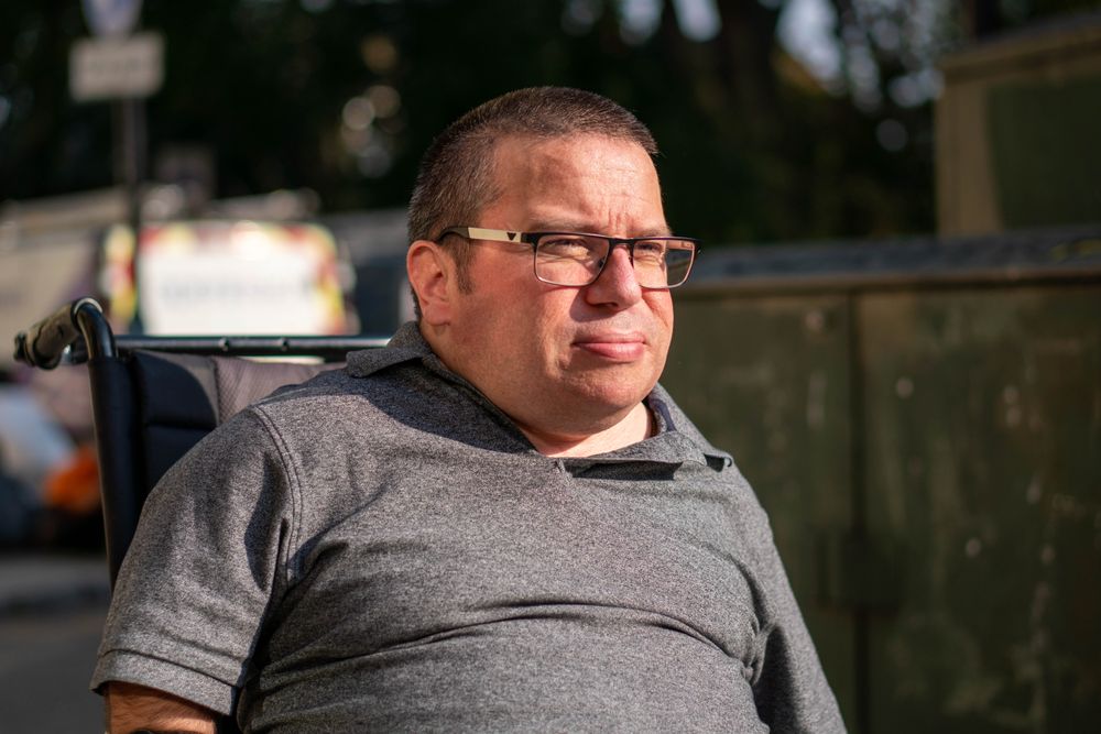 Portrait of man in wheelchair outside