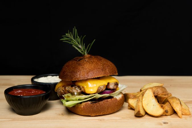 Sauces near burger and fried potato