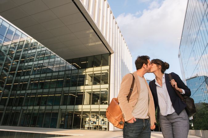 Businesspeople couple outside contemporary building