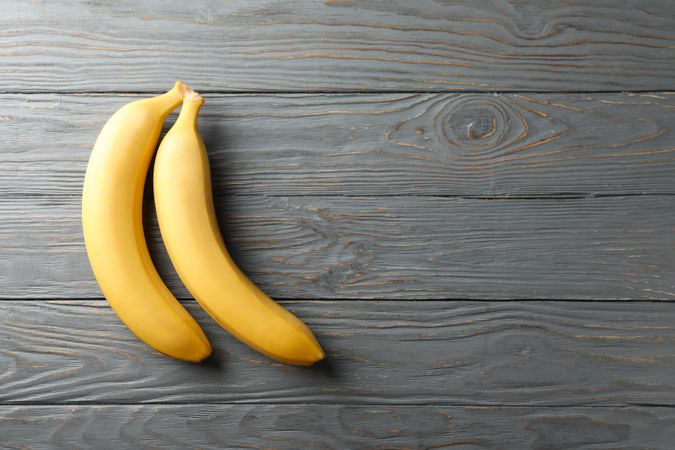 Bananas on gray wooden background. Fresh fruit