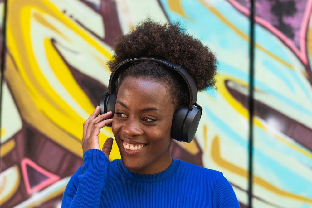 Positive woman enjoying music in city