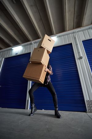 Anonymous person with cardboard boxes