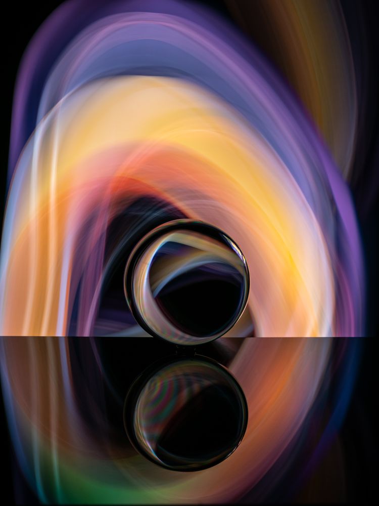 Crystal ball on board near abstract shines