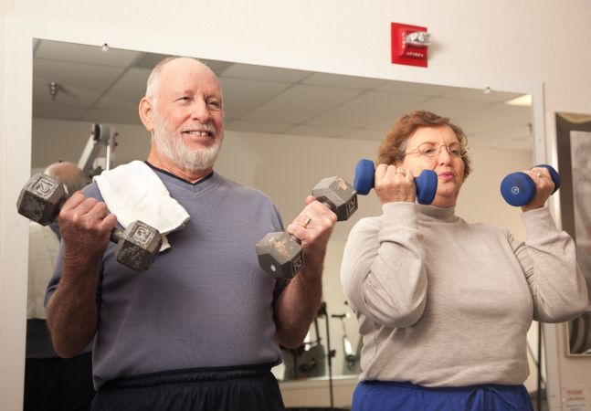 Mature Adult Couple Working Out in the Gym