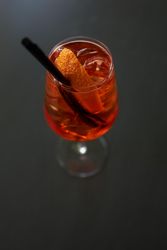 Orange cocktail with garnish and straw
